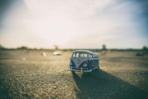 Shallow focus photography of white and teal die-cast Volkswagen Samba with sunlight