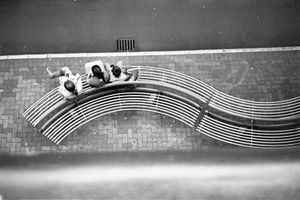 Monochrome aerial photography of people sitting on a bench