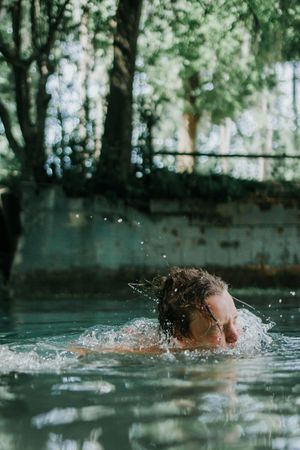 Woman swimming on body of water during daytime