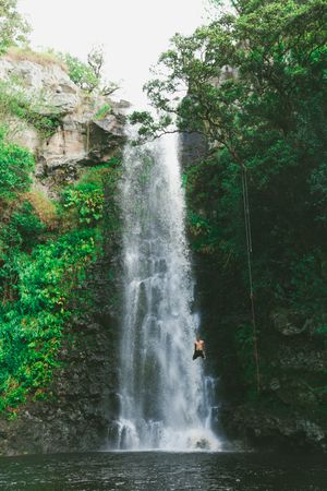 Man jumping a waterfall